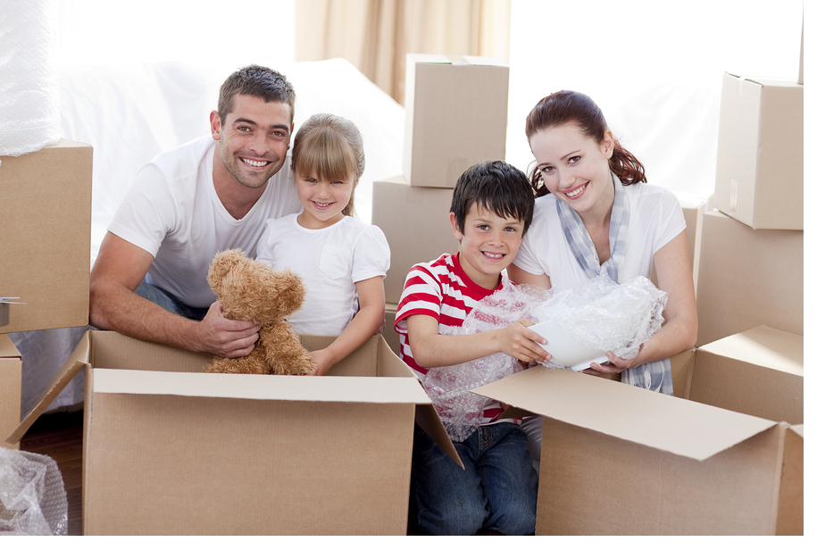Family unpacking boxes together in their new home